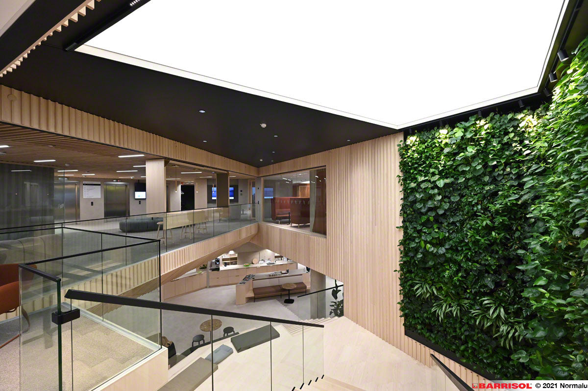 Modern office interior with large white stretch ceiling light